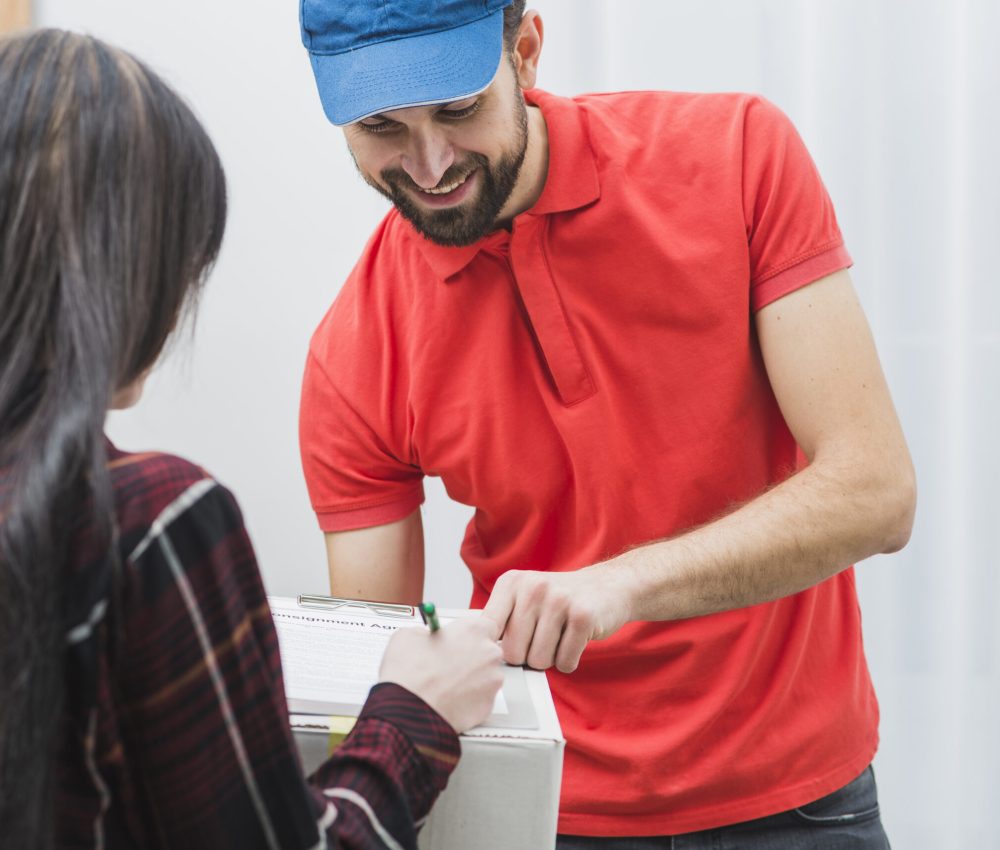 cheerful-courier-pointing-clipboard-woman-scaled.jpg