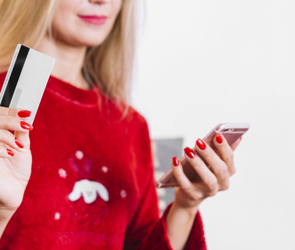 woman-with-smartphone-plastic-card-scaled.jpg